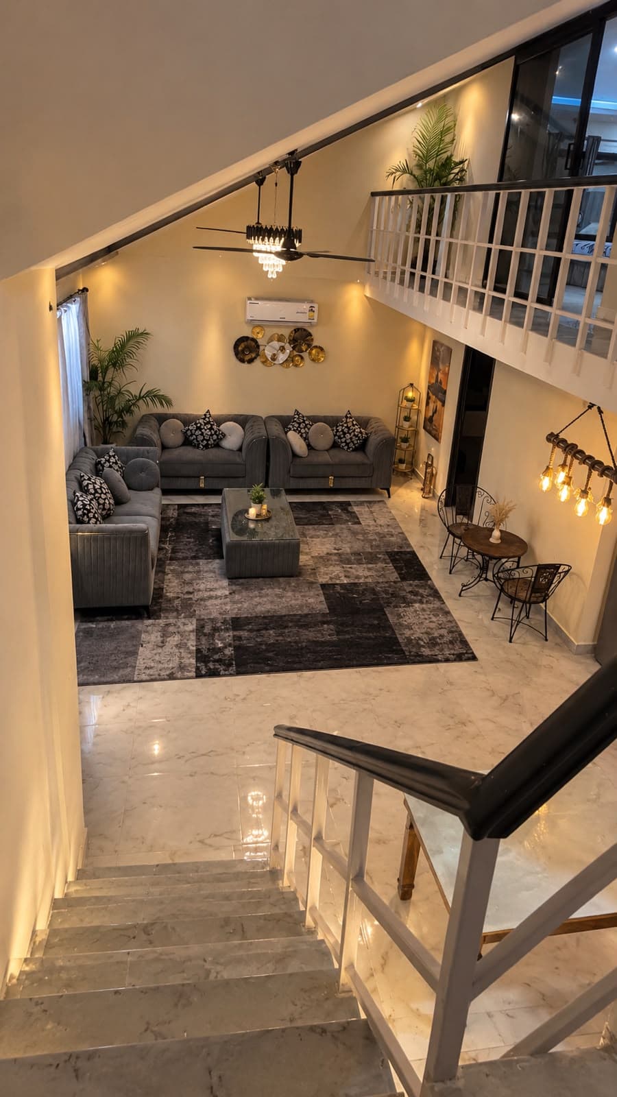 Indoor lounge with staircase and warm lighting
