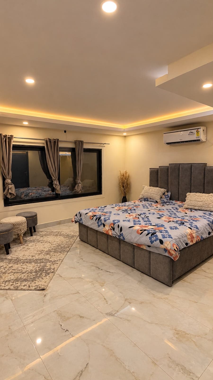 Comfortable bedroom with curtains and warm lighting