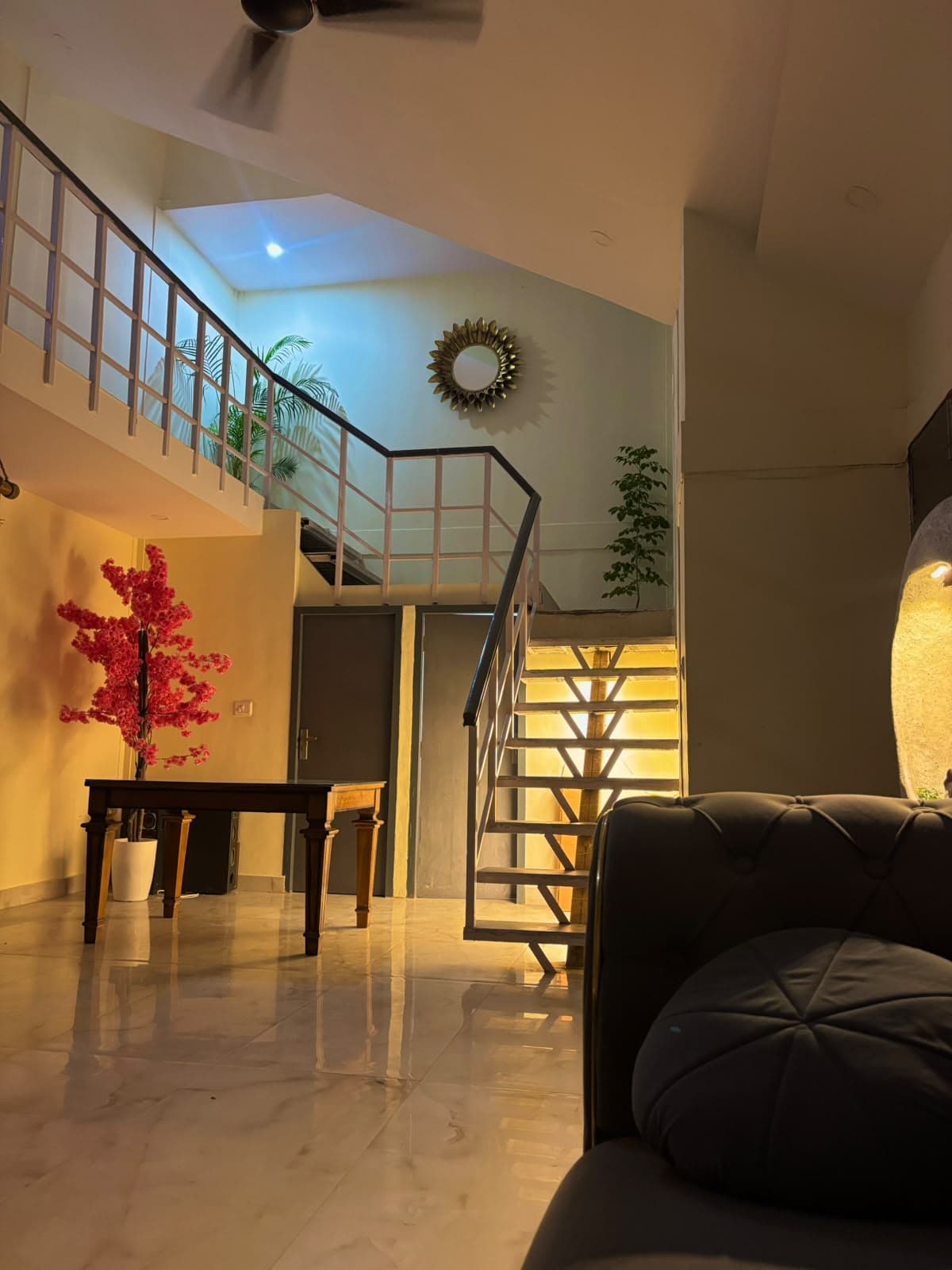 Indoor sitting area with staircase and sofa
